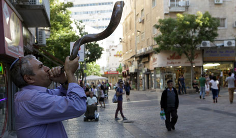 Shopkeeper plays a shofar