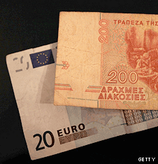 An old drachma note and a euro note
