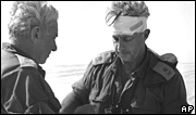 Maj Gen Ariel Sharon, right, views a map with Maj Gen Haim Bar-Lev in the Sinai desert, in October 1973