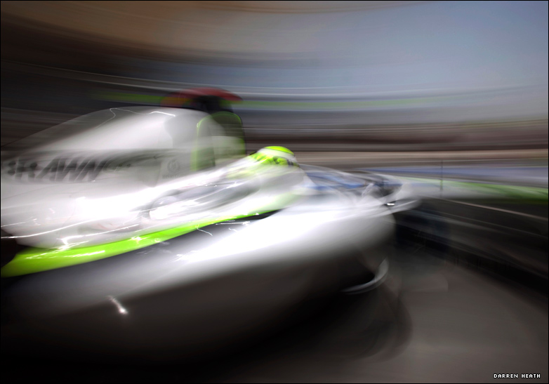 Blurred in-motion shot of Jenson Button's Brawn GP car