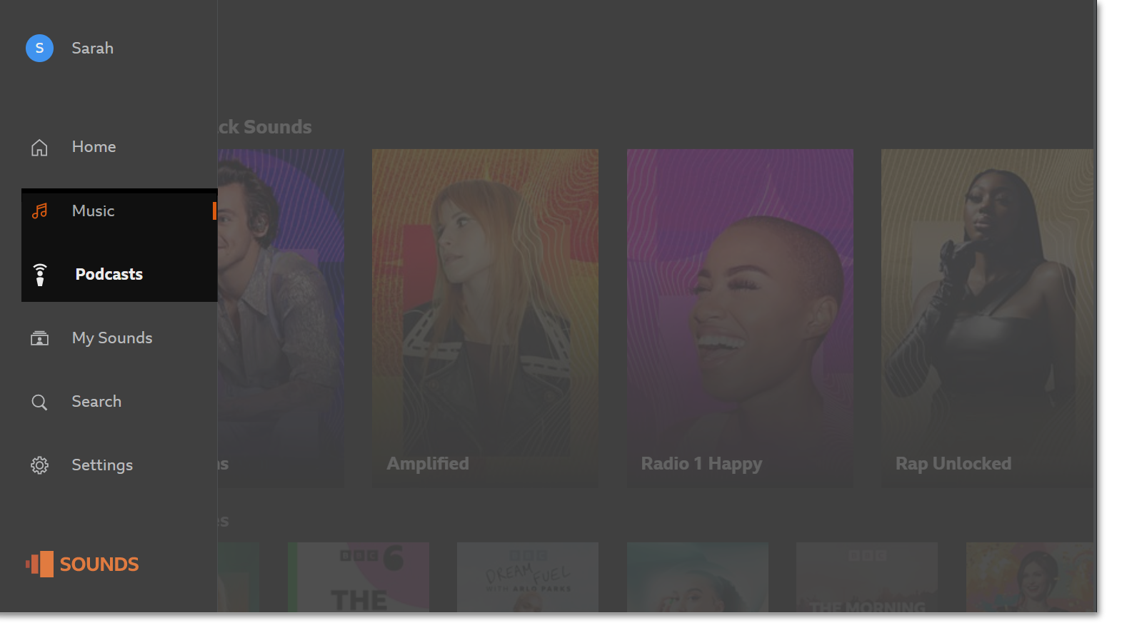 The BBC Sounds TV app homepage with the Music and Podcasts menus highlighted on the left hand side