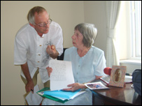 Joan and Frank going through her records.