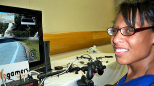 Smiling woman playing a switch-controlled computer game