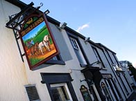 Photograph of a street and pub sign
