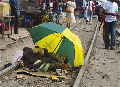 A mother takes a rest with her children on a railway line in the Agege area of Lagos. 