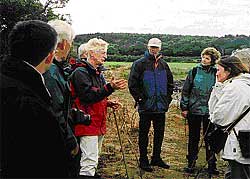 Tom McErlean (centre) explains stone fish trap design
