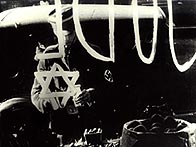 Member of Hitler Youth paints a 'Star of David' on a Jewish-owned shop