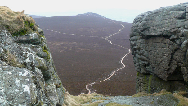 Path winds across distant hillside