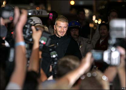 David Beckham surrounded by photographers