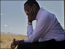 Alvin Hall sitting in a field