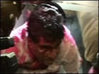 Minister Mervyn Silva being escorted by police