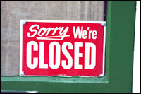 Sign in shop door which says Sorry we're closed.