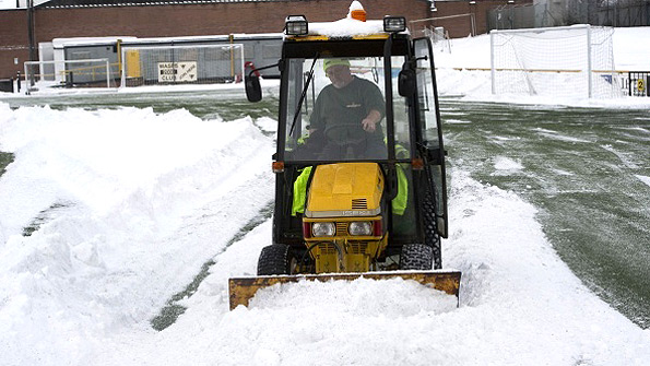 The groundsman at Alloa clears the snow from the artificial surface at Recreation Park. Photo: SNS