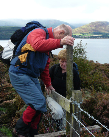 A walker crossing a stile