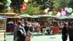 Festival-goers dining at the outdoor bar in George Square Gardens