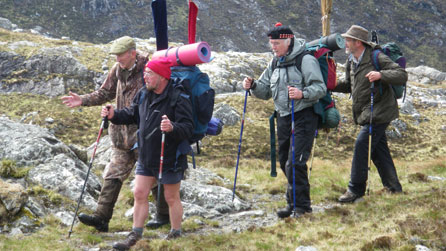 Ghillie Cathel MacLeod with Aly Bain, Billy Connolly and Andrew Greig (right) start their trek into the Assynt mountains 