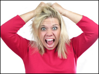 A woman pulling at her hair in frustration