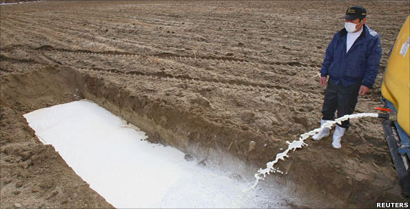Milk being drained into field