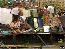 Residents clean up in a damaged Rangoon suburb on 4 May 2008