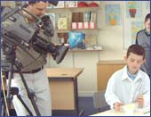 Image of a a pupil being filmed while painting