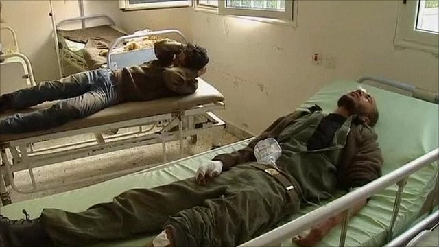 Picture showing injured men in hospital beds