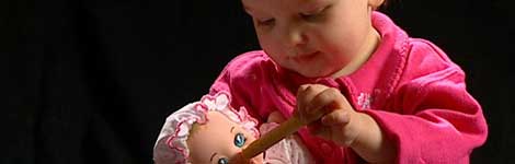Child plays with doll
