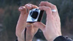 hands holding compact camera