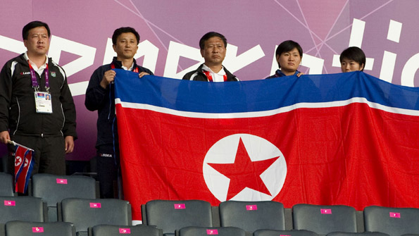 North Korean athletes hold their national flag