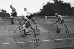 People racing on penny farthing bikes