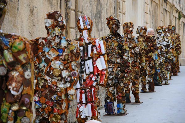 A queue of people made out of rubbish.