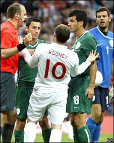 Wayne Rooney and Slovenia players