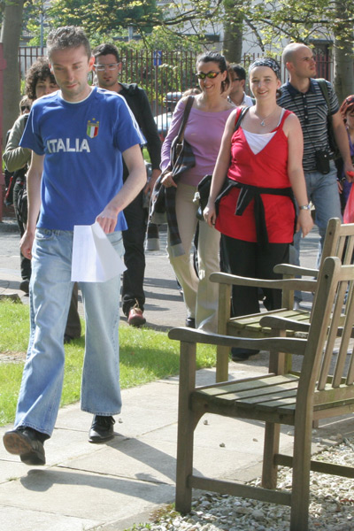 Barry Byrne leads the audience from the Magee Language School to the Radio Foyle garden.