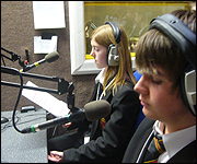 Two student presenters in front of the microphone