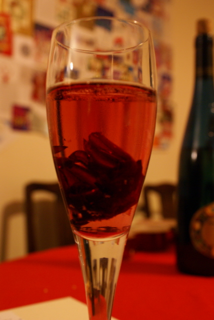 champagne with a wild hibiscus flower in it. yes you could be excused for thinking a spider had drowned there.