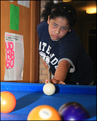Raven at the pool table during youth club