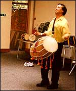 Playing the dhol drum