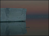 A whale has just disappeared as the sun sets