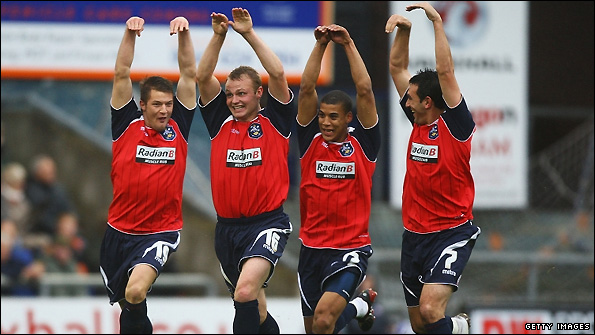 Huddersfield celebrate scoring in a League One fixture at Oldham