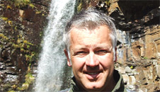 Derek next to an impressive waterfall on the walk
