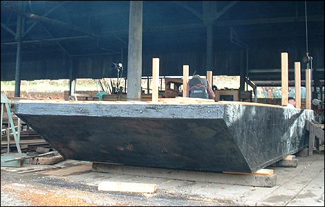 The broad hull has been covered with pitch to protect it when it's in the water