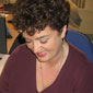 Anne Marie at her desk in BBC Broadcasting House, looking through some get well cards