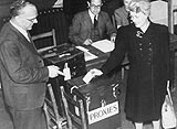 Photo of a woman who is voting by proxy for her husband who is stationed overseas, during the 1945 General Election