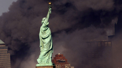 Statue of Liberty in front of smoking buildings © Statue of Liberty in front of smoking buildings