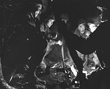 Troops recounting an operation, around camp fire