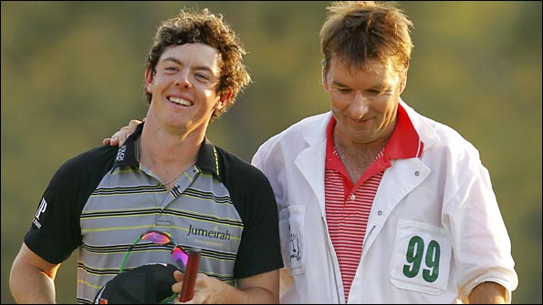 McIlroy raises a smile as he walks off the 18th green with his caddie