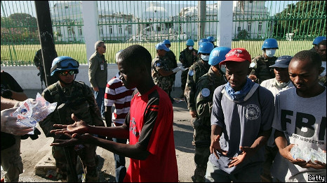 People receive water from an United Nations distribution point