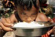 An Indian boy eating rice