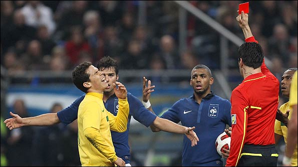 Brazil's Hernanes is shown the red card against France