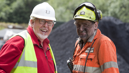 Rolf Harris chatting to a miner