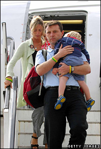 McCann family emerging from aeroplane